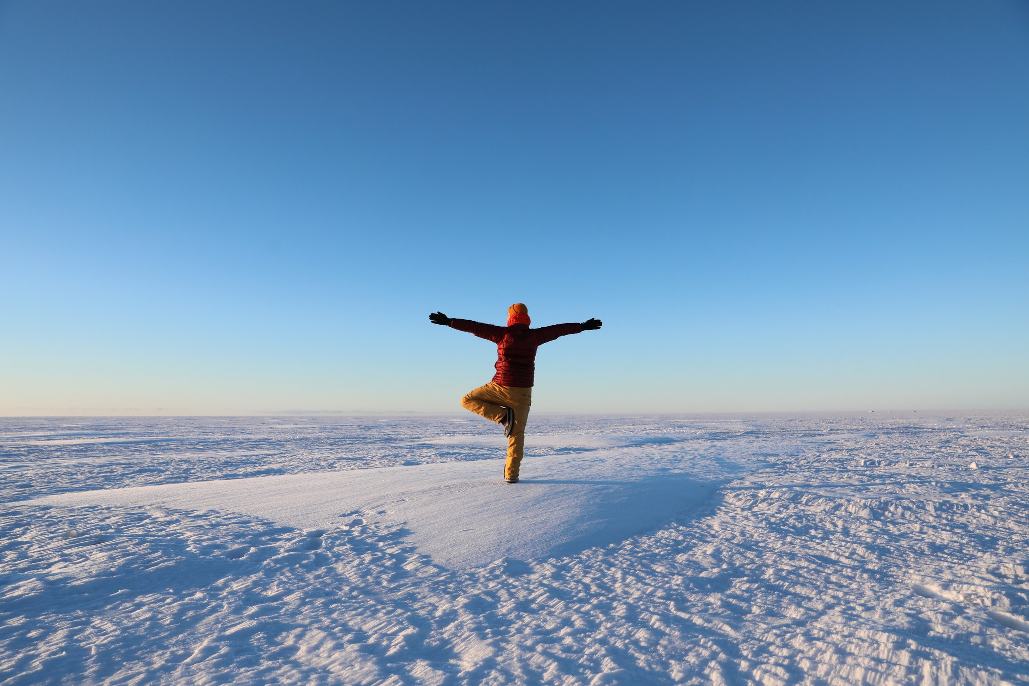 Happy person dancing on the sea ice in winter