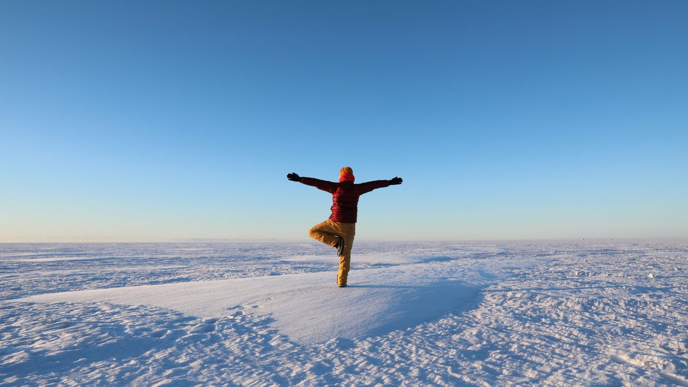 Happy person dancing on the sea ice in winter