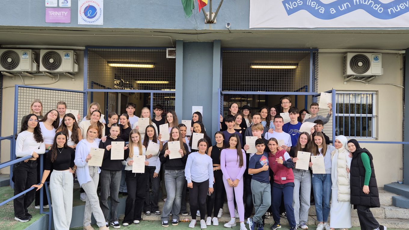 students in front of school in spanish national costumes