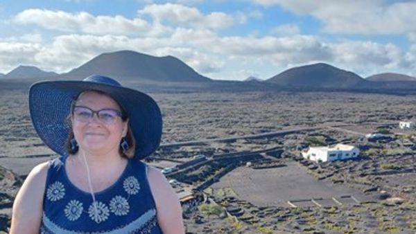 Teacher in front of a desert landscape