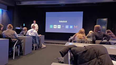 people in a classroom with a screen