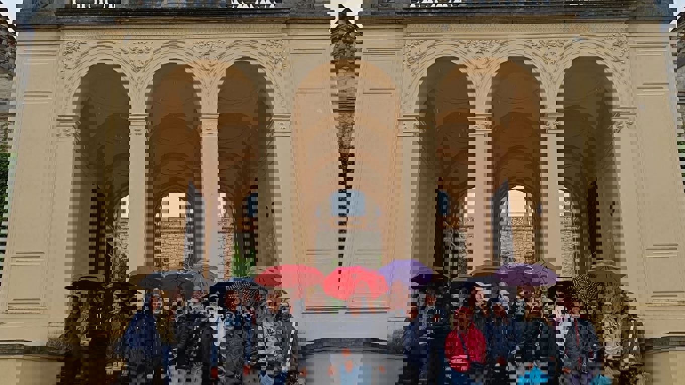 students in front of a gate