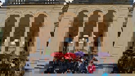 students in front of a gate