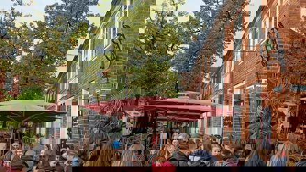 people in front of an orange building